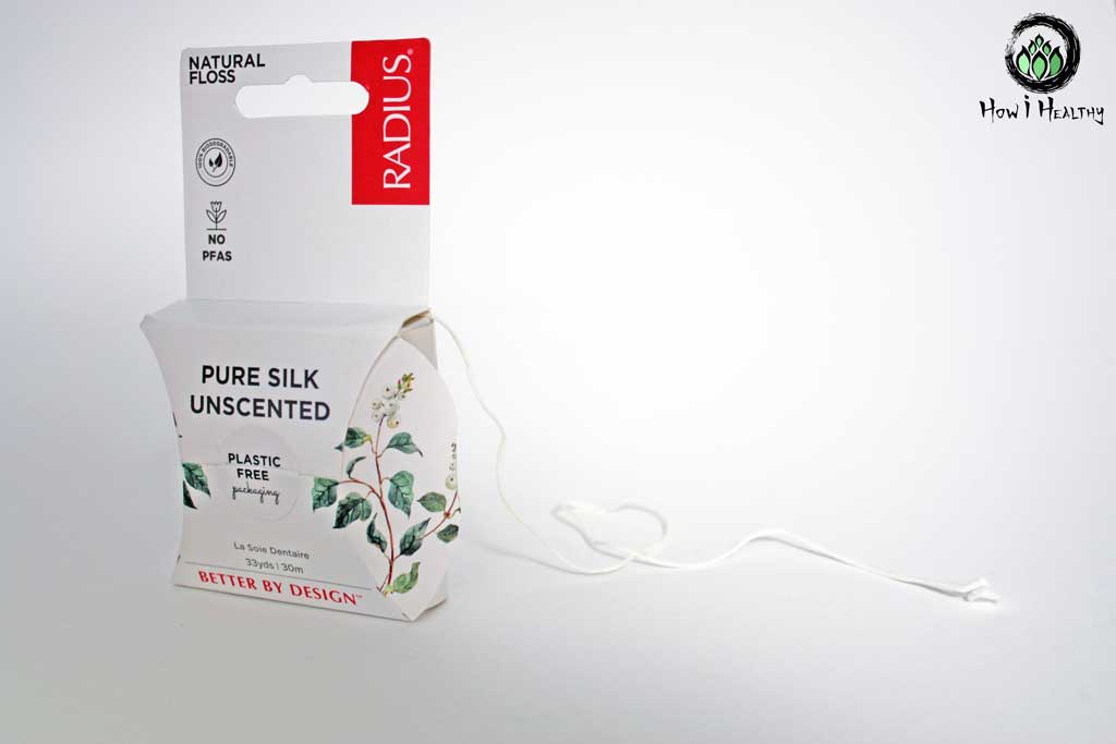 RADIUS® white silk floss coming out of paper product box.