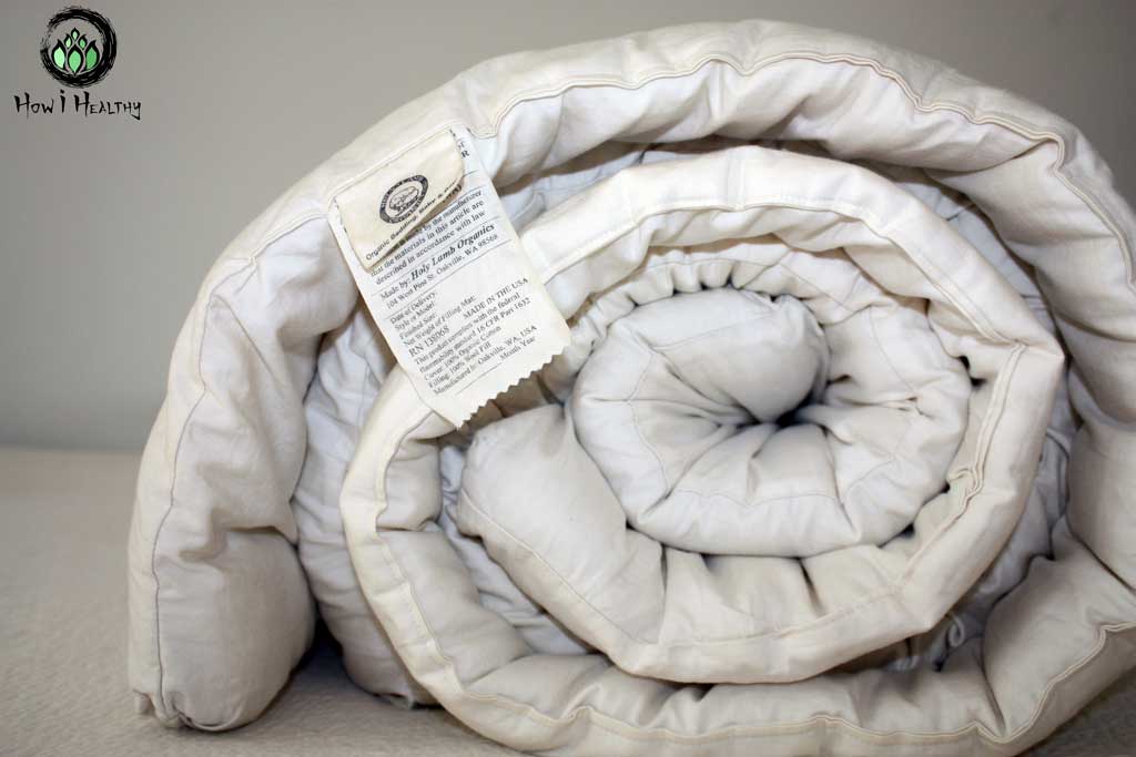 A rolled up Holy Lamb® wool comforter.