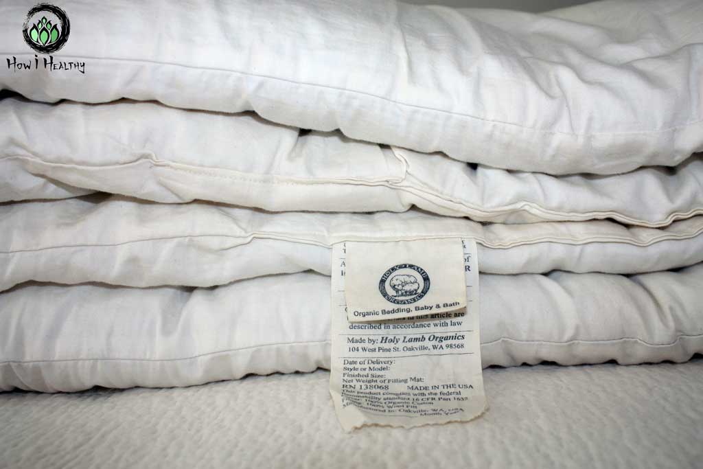 Folded up Holy Lamb® white wool comforter.