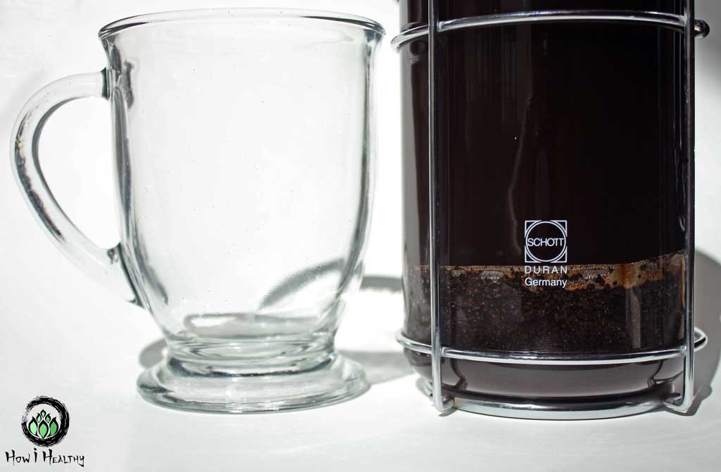 German-made glass French press and empty glass mug.