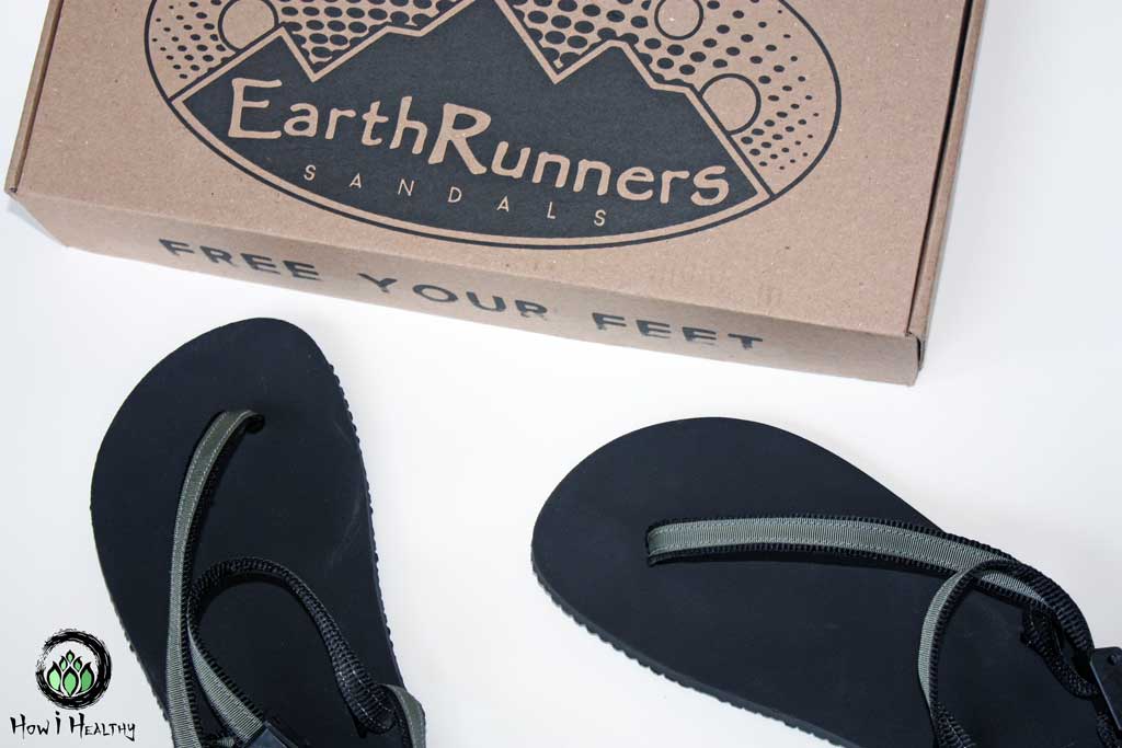 EarthRunners® minimalist sandals next to product box.