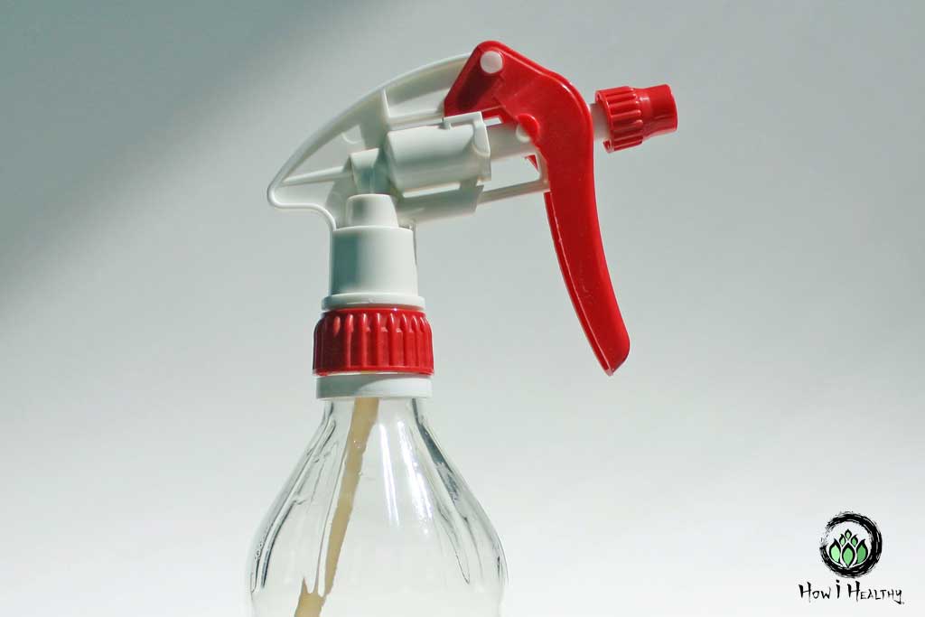 DIY glass spray bottle with red nozzle.