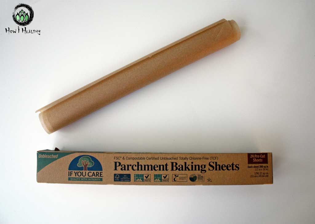 Rolled up brown compostable baking parchment beside box.