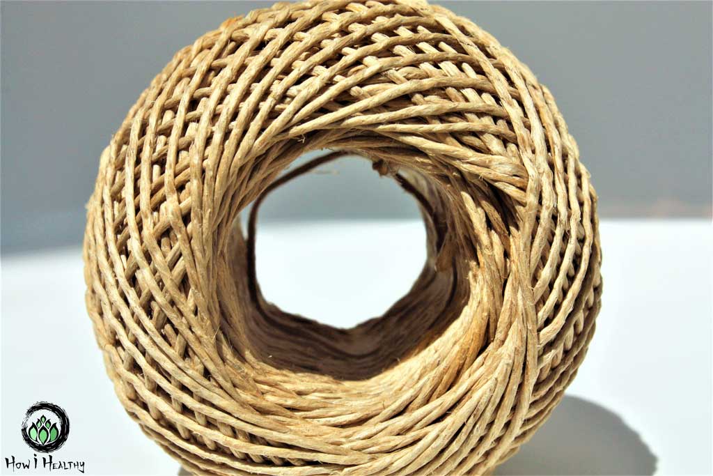 Rolled ball of twine on its side, showing through the center hole.