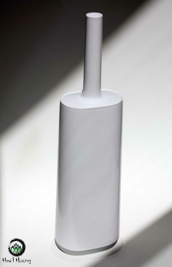 A white plastic toilet brush inside its plastic holder.