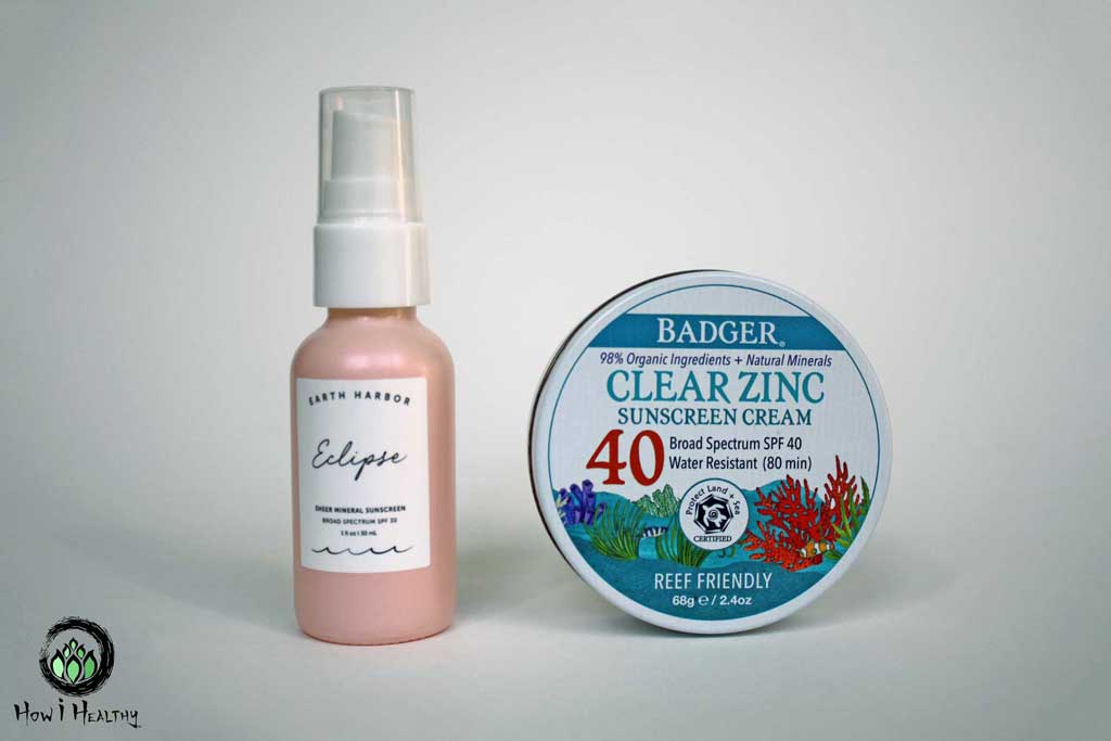 One tin mineral-based sunscreen beside a pink pump mineral-based sunscreen.