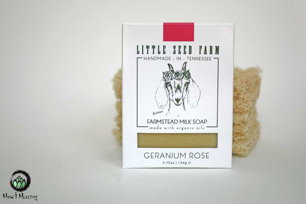 Little Seed Farm goat milk soap in front of a loofa sponge.