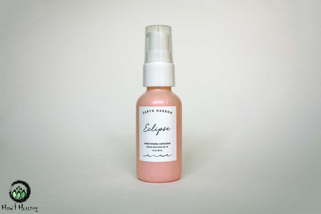 Earth Harbor sunscreen in pink glass pump bottle.