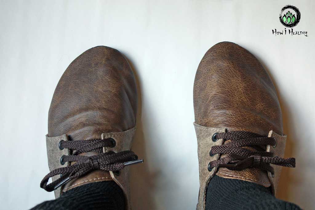 Softstar leather sneakers with tied brown laces.