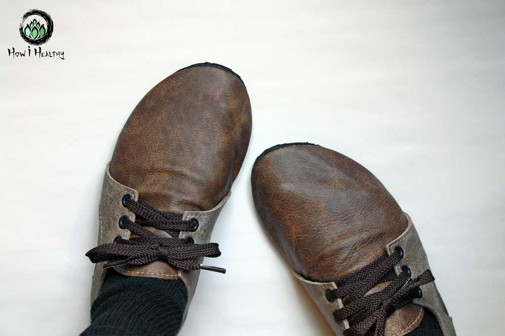 Softstar leather sneakers with tied brown laces.