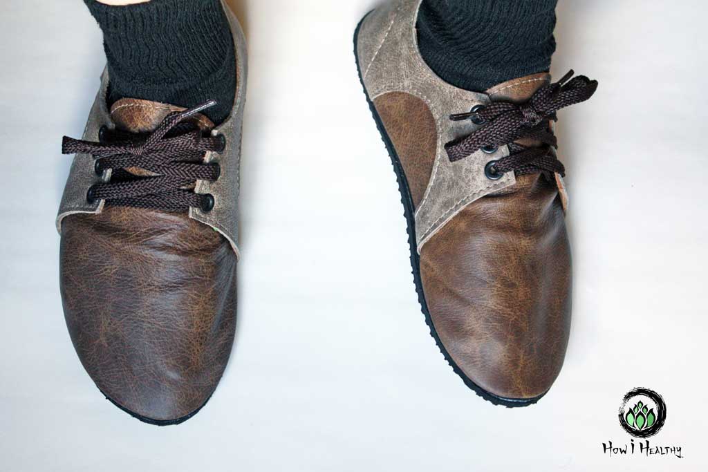 Softstar leather sneakers with tied brown laces.