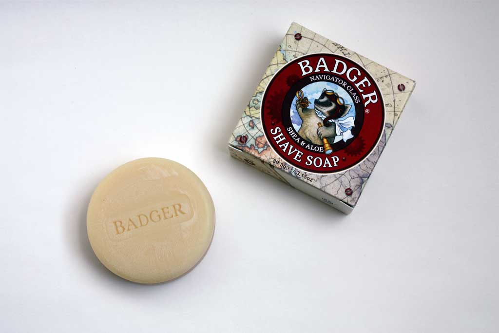 Badger shaving bar soap beside packaging.